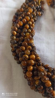 13 Inch Natural tiger eye Smooth Round Loose Beads brown colour 6mm Stone : Natural tiger eye Length - Approx 13 inch Shape :- Round Size :- approx 6mm 8mm Polish :- Handmade Purity :- 100% Natural Gemstone color - brown It is known as the 'love stone' as the message it emits is the strong vibration of unconditional love, joy, warmth and healing. As quartz crystals are profound amplifiers of energy, it may help to kindle happiness, love, romantic feelings and sensuality. It is good for people in Polished Round Brown Beads, Brown 8mm Round Beads, Brown 8mm Beads, Romantic Feelings, Carnelian Bracelet, Boho Style Earrings, White Tassel, 108 Bead, Brown Colour