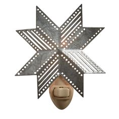 a light that is on the side of a wall with a star decoration above it