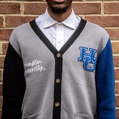 "Make a bold statement and wear your Hampton pride with this one-of-a-kind and comfortable cardigan sweater, perfect for any alumni, students or supporters. Made with the highest quality materials, this sweater is designed to keep you warm and cozy while representing Hampton. Features: - Official Hampton University logo embroidered on the chest - Large \"HU\" Logo Chenille patch - Classic cardigan design with a tortoise shell button-up front - Two front pockets (deep enough to fit a phone and other essentials) - Soft and durable fabric for long-lasting comfort - Available in a range of sizes to fit everyone - Versatile and fashionable, perfect for both casual and formal occasions Discover More Officially licensed Hampton University Apparel Celebrating Black excellence. Building legacy. Joi Varsity Cardigan For Winter College Season, Varsity Style Cardigan For College In Winter, Varsity Style Winter Cardigan For College, Winter Varsity Cardigan, Sporty Fall Cardigan For College, Collegiate Cotton Long Sleeve Cardigan, Collegiate Long Sleeve Cotton Cardigan, Collegiate Cardigan For College In Fall, Collegiate Long Sleeve Cardigan For College