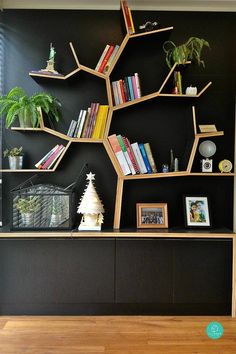 a bookshelf with shelves filled with books and plants on it's sides