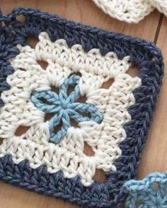 two crocheted squares with blue and white flowers on them