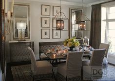 a dinning room table and chairs with candles on it