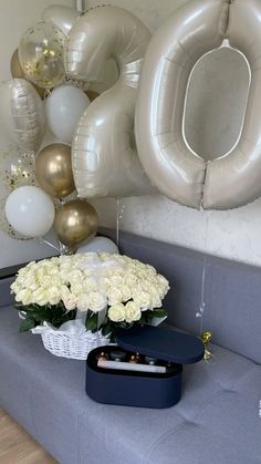 white flowers and balloons are on the couch