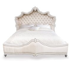 a white bed with an upholstered headboard and foot board on the side