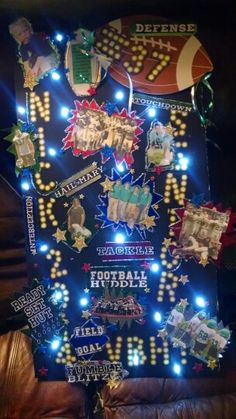 a christmas tree decorated with lights and sports related items in the shape of an american football team