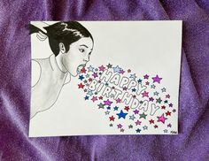 a drawing of a woman blowing out her birthday candles on purple fabric with the words happy birthday written across it