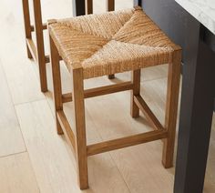 three wooden stools sitting next to each other on top of a hard wood floor