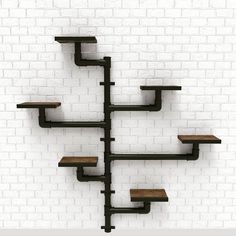 a wall mounted shelf with shelves in the shape of an upside down tree, against a white brick wall