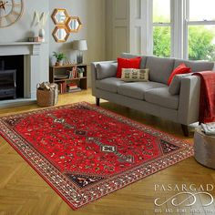 a living room filled with furniture and a red rug