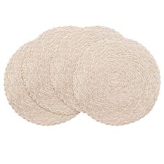 three round rugs on top of each other in different colors and sizes, one beige