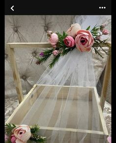 a white veil with pink flowers on it