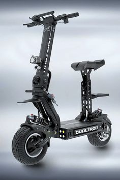 an electric scooter with two wheels on the front and rear wheel in black