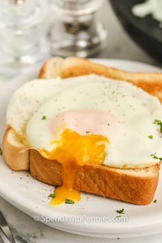 an egg on toast with melted cheese and parsley is shown in the foreground