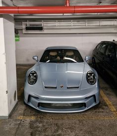 two cars parked in a parking garage next to each other