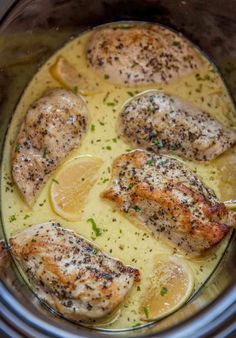 chicken with lemon sauce in the crock pot ready to be cooked and served for dinner