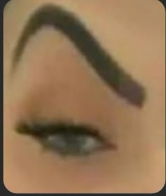 a woman's eye with long lashes and eyebrows