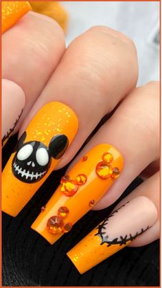 Immerse yourself in the Halloween season with these captivating Disney-inspired nail designs that will bring a sprinkle of enchantment to your manicure! Our skilled nail technicians are adept at crafting intricate nail art inspired by iconic Disney characters and spooky themes. Whether you desire an elegantly eerie look channeling Maleficent or a playful design featuring Jack Skellington, your nails are sure to radiate Disney charm. Disney Themed Nails, Disney Halloween Nails, Halloween Nail Art Tutorial, Mickey Mouse Nails, Halloween Acrylic Nails, Pumpkin Nails, October Nails, Nail Art Disney