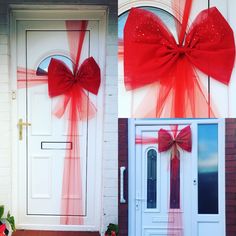 two red bows tied to the side of a white door with flowers in front of it