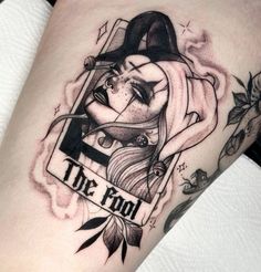 a woman's leg with a tattoo on it and the word, the fool