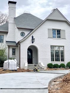 a large white brick house with a chimney