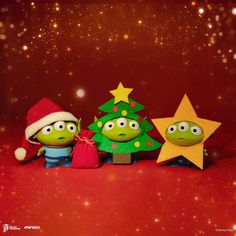 two green cartoon characters standing next to each other in front of a christmas tree and star