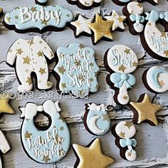 baby shower cookies decorated with blue and gold stars, moon and crescents on a white wooden background