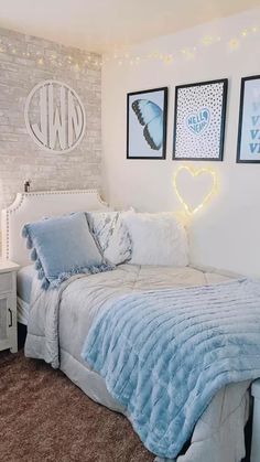 a bedroom with white walls and blue bedding