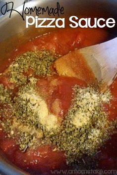 homemade pizza sauce in a pot with a wooden spoon