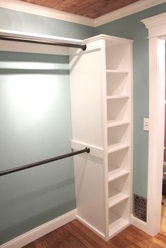 an empty closet with shelves and some rails