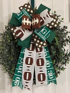 a football themed wreath hangs on the front door, decorated with green and white ribbon