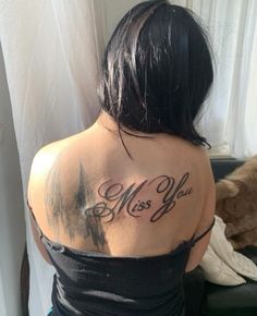 a woman with a tattoo on her back