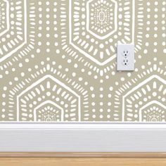 a light switch is shown in front of a wall with an intricate pattern on it