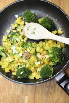 broccoli and other vegetables are being cooked in a skillet