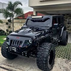 a black jeep parked in front of a house