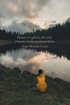 a person sitting in front of a lake with a quote on it that reads nature is a gift for the soul, oneness in her profound flow