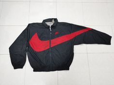 Please read all description carefully before buying. If you have any questions feel free to ask. Vintage 90's Nike Big Swoosh  Colour : Black, red Size on tag : M Brand : Nike Condition : Good condition. MEASUREMENT Armpit to armpit : 26" Shoulder to bottom hem : 27" PLEASE CHECK ACTUAL SIZE CAREFULLY, NO RETURNS OR COMPLAINT FOR WRONG SIZE ACTUAL. ACCEPT PAYPAL ONLY.  Shipping cost is $28 via DHL Express wordwide shipping. Transit time can take 3-5 business days to reach destination.  Please leave your phone number on the note while make a purchase, as the shipping company always need the phone number to help delivering.  This item will be ship along with Tracking Number after received a completed payment. Thank u for visit. Happy shopping. 😎l Baggy Hoodie, Black Red, Happy Shopping, Gender Neutral, Jackets & Coats, Track, Adult Outfits, Bathing Beauties, Nike