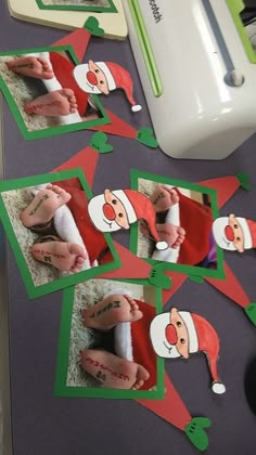 several pictures of santa claus are on the table next to a sewing machine and scissors