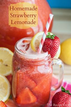 homemade strawberry lemonade in a mason jar with strawberries and lemons