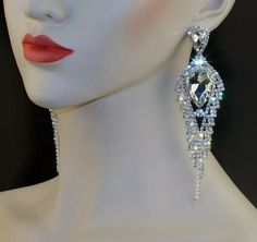 Style: Marquise pointed teardrop pave accented rhinestone statement earrings Color: Diamante rhinestones on silver Length: 5.25″ Post W/Pushback Closure Silver Crystal Bridal Earrings For Glamorous Events, Silver Rhinestone Earrings For Glamorous Events, Silver Earrings With Rhinestones For Glamorous Events, Glamorous Crystal Chandelier Earrings With Rhinestones, Diamond White Crystal Earrings With Rhinestones For Party, Dazzling Teardrop Crystal Chandelier Earrings, Diamond White Rhinestone Crystal Earrings For Party, Glamorous Crystal Teardrop Earrings, Party Crystal Earrings With Rhinestones In Diamond White