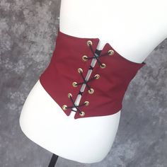 "This waist cincher is made in 100% Cotton in WINE RED.. The perfect compliment to your Witch, Pirate, Renaissance, Medieval or other fantasy cosplay costume. It is lined with cotton duck and it has spiral steel boning in the front for stability and to reinforce the grommets. A very comfortable, yet sturdy piece. Measure your waist as the smallest point (typically just about the belly button) and choose from the following sizes: X-SMALL: Waist 25.5 - 28 inches (64 - 71 cm) SMALL: Waist 28 - 31 i Punk Corset For Costume Party And Cosplay Events, Punk Style Corset For Cosplay Events, Steampunk Underbust Corset Belt For Costume, Punk Corset For Halloween Larp, Gothic Corset Belt For Costume Party, Gothic Underbust Corset Belt For Costume, Steampunk Corset Belt For Cosplay, Fantasy Corset Belt With Corset Back For Cosplay, Fantasy Corset Belt For Cosplay With Corset Back