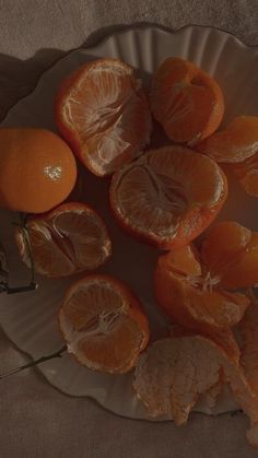 an orange cut in half on a plate