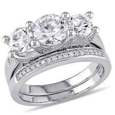 three stone engagement ring set with diamond accents