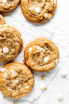 white chocolate chip cookies with marshmallows arranged on parchment paper, top view