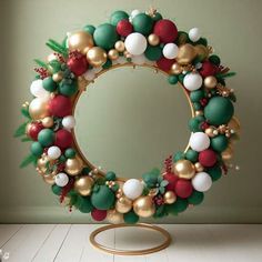 a christmas wreath on top of a gold stand