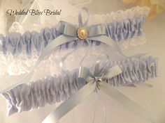 Wedding garter set . One to keep , one to throw. Classic blue garters for the tradition of something blue. Made with lingerie elastic for comfort . Elegant keepsake garter edged with white lace and blue ribbon , throw garter satin band, embellished with blue ribbon bows . * Garters stretches to 55cm ,PM  your thigh measurement ,for  a custom fit  * Lace edged garter Width 5cm , 2 inches * Satin Band garter width 2 cm, 1"inches . Presented in organza  keepsake pouch for the Bride to be Blue Garter, Wedding Garter Set, Wedding Garter, Garter Set, Wedding Item, Garters, Lace Edging, Blue Ribbon, Something Blue