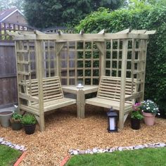 a wooden bench and table in a garden