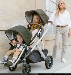 a woman is walking next to a child in a stroller