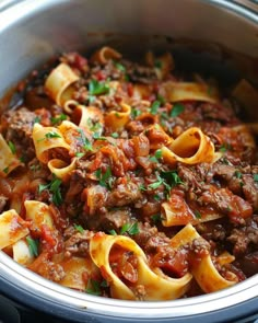 a pot filled with pasta and meat sauce