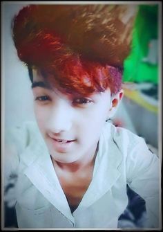 a young man with red hair wearing a white shirt