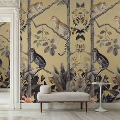 the wallpaper in this room is decorated with leopards and leaves